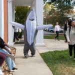 A student dresses up as a giant shark as part of the fall fun for the Halloween Costume Contest.