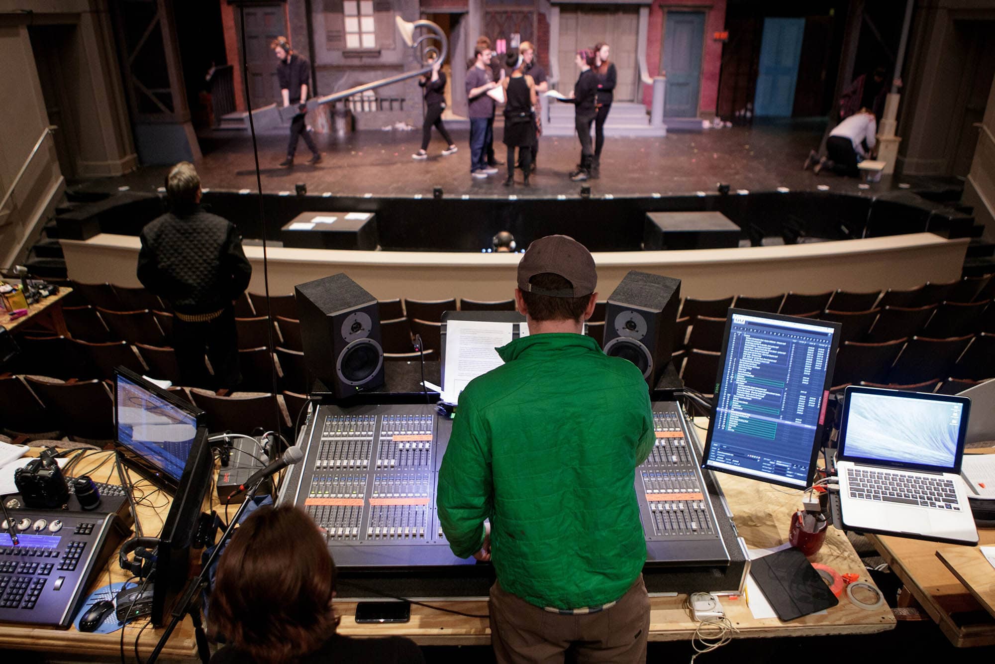 man operates sound board for theatrical production