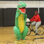 A student dresses up in an inflatable dinosaur costume for the costume contest at the Spirit Week pep rally.