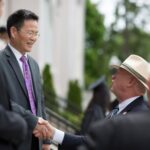 Georgia Sen. Butch Miller greets Jinze Zheng, director of the project department for Anhui Normal University, on Saturday, May 5, at the 2018 Spring Commencement Ceremony on Brenau University's historic Gainesville campus. (Nick Bowman for Brenau University)