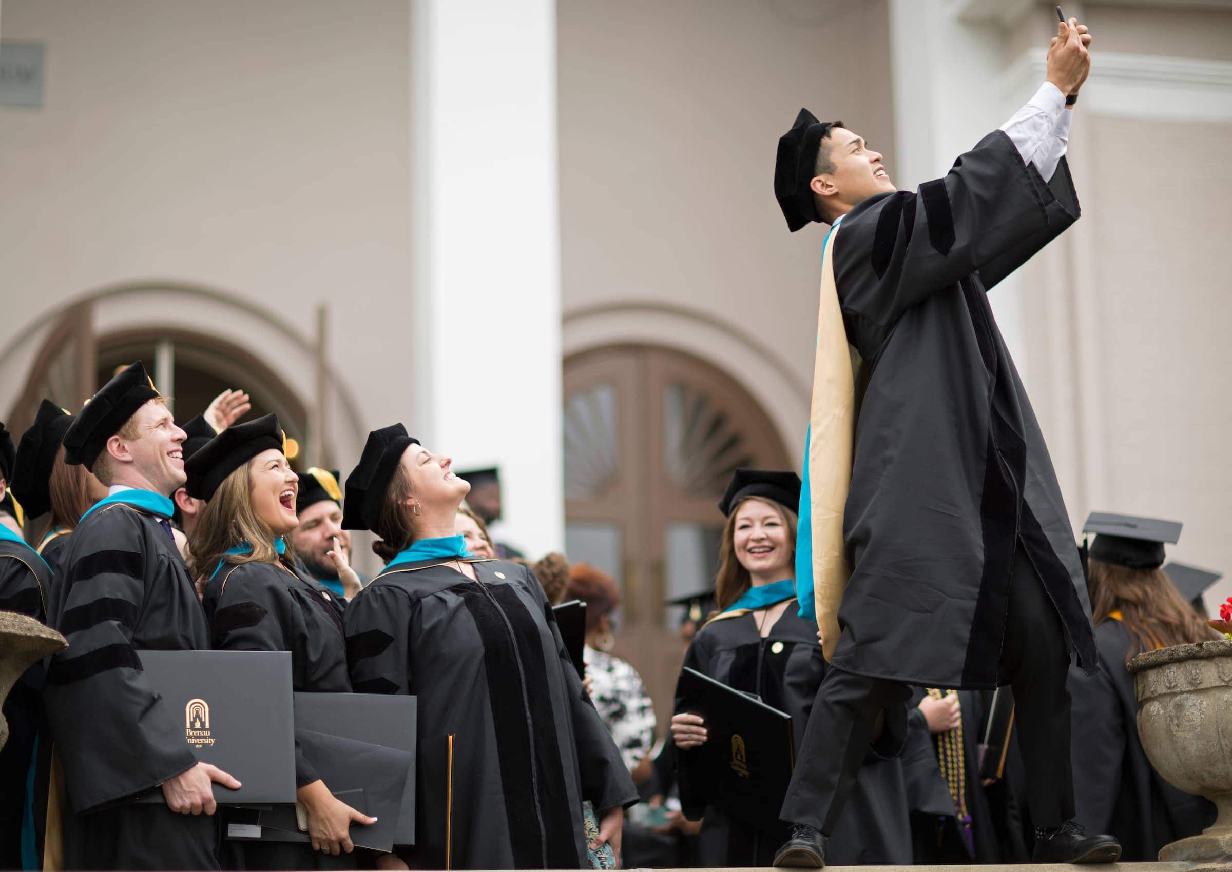 Andrew Phan takes a selfie with his fellow members of the inaugural Doctor of Physical Therapy cohort following the 2018 Spring Commencement Ceremony on Saturday, May 5, on Brenau University's historic Gainesville campus. (Nick Bowman for Brenau University)
