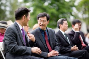 Jinze Zheng (left), director of the project department for Anhui Normal University, speaks with Qingsong Sang, dean of the School of Education, during the 2018 Spring Commencement Ceremony on Saturday, May 5, at Brenau University.