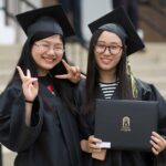 Ling "Becky" Xu (left) and Xingyi "Lisa" Wang smile after the 2018 Spring Commencement Ceremony on Saturday, May 5, on Brenau University's historic Gainesville campus. (Nick Bowman for Brenau University)