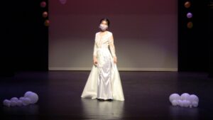 White lace wedding dress on a model during a runway show at Brenau University.