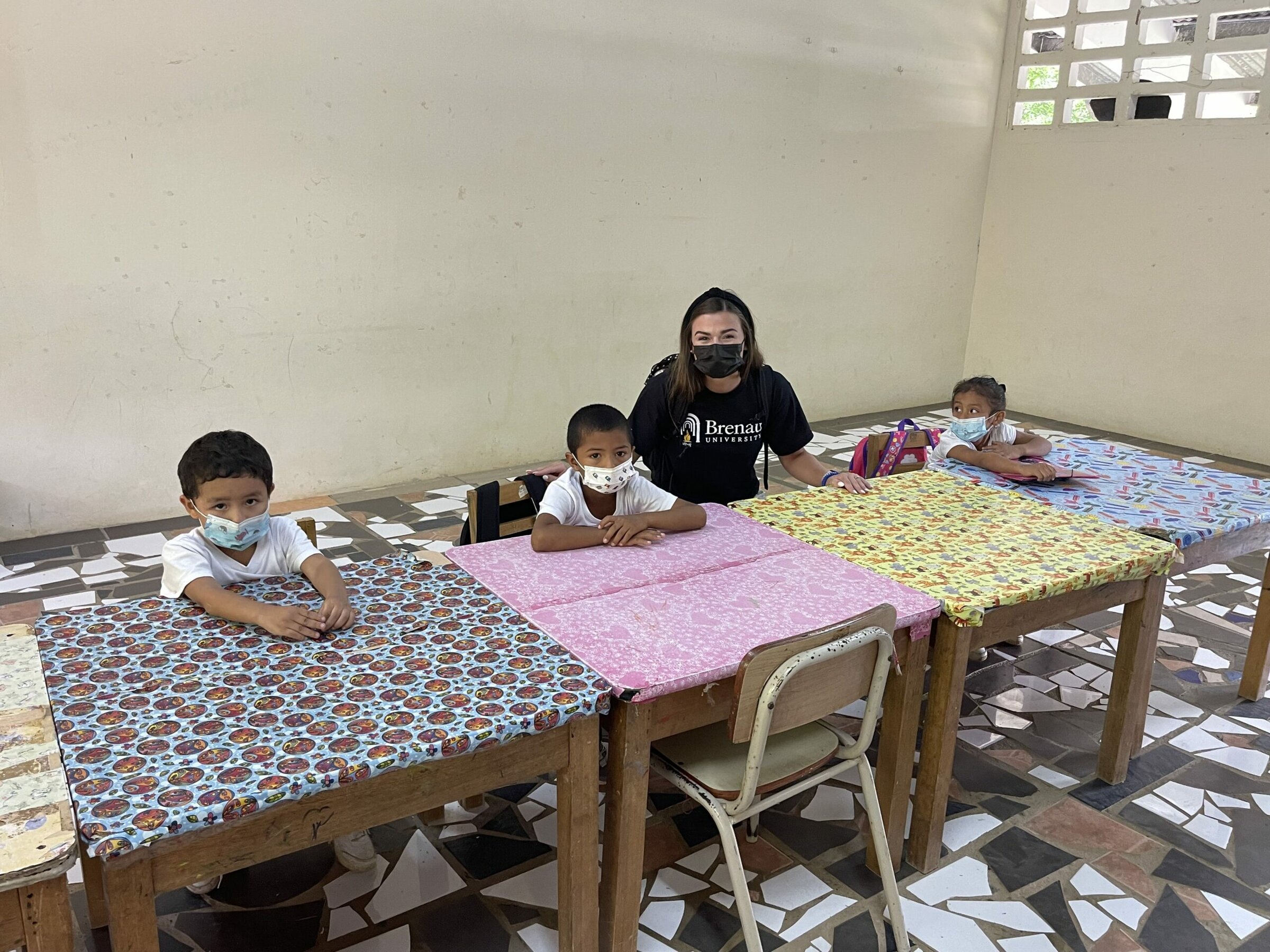 Annabeth Vandiver poses with three school children in Panama