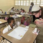 Sarah Nolan works with a student in Panama