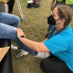 A PT student treats a farmworker's leg
