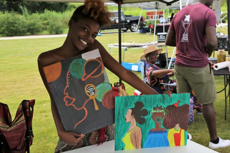 Woman holding juneteenth artwork