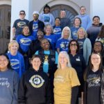 Faculty and staff gather for a photo in the Golden Tiger Spirit wear