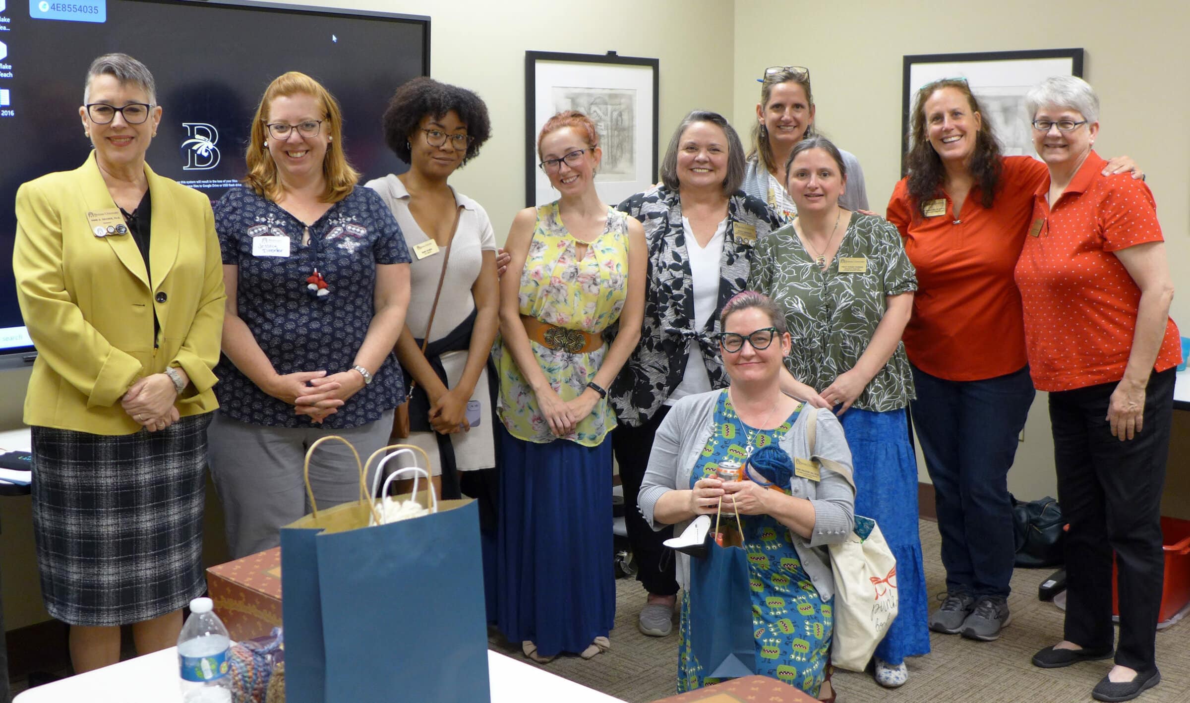 faculty and staff with president smiling