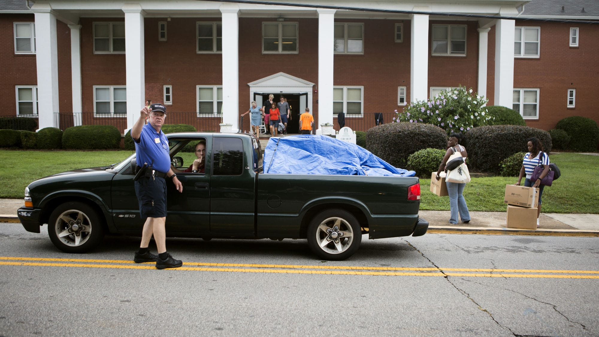 Security officer directs traffic on move in day