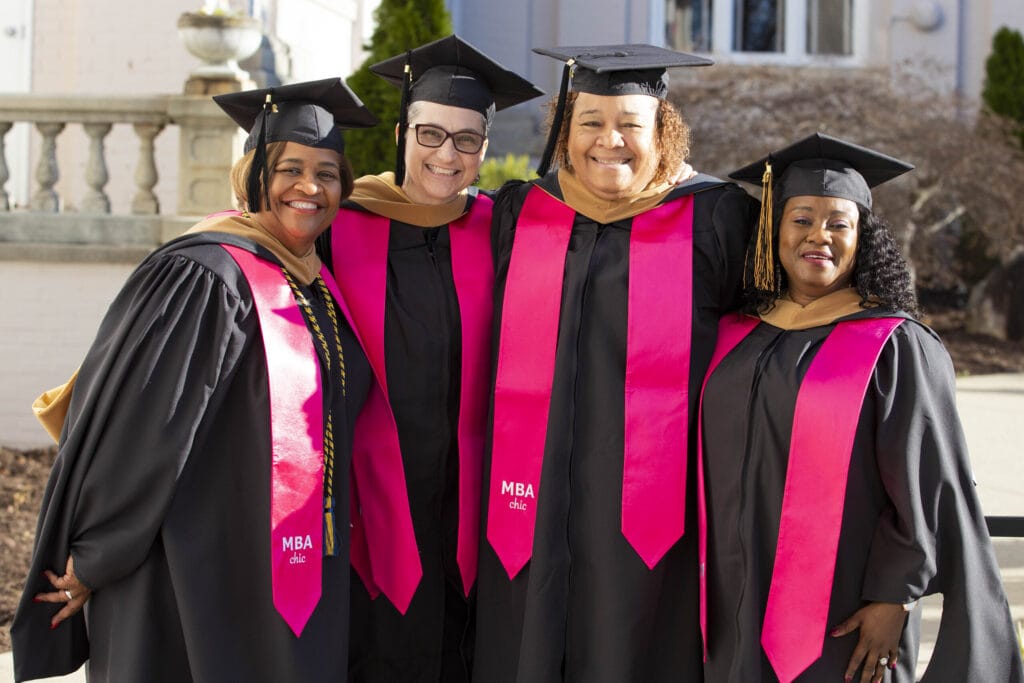 Executive Women's M.B.A. graduates pose for a photo after the ceremony.
