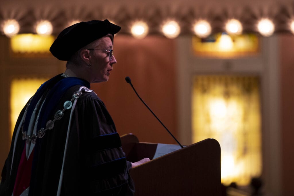 President Anne Skleder speaks at a podium during winter commencement.