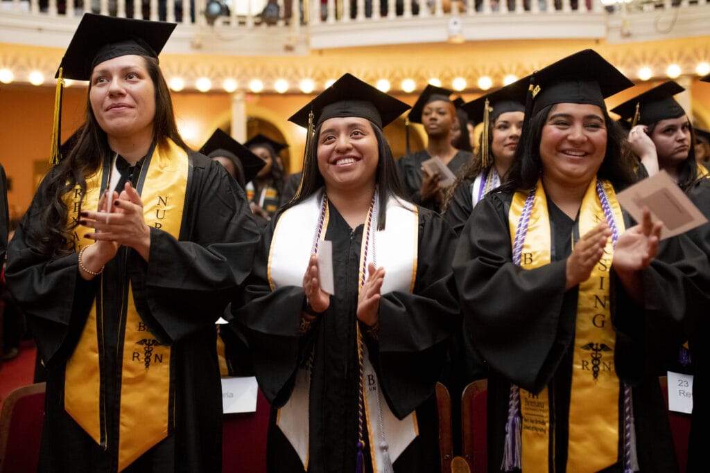 Graduates applaud during the undergraduate commencement ceremony.