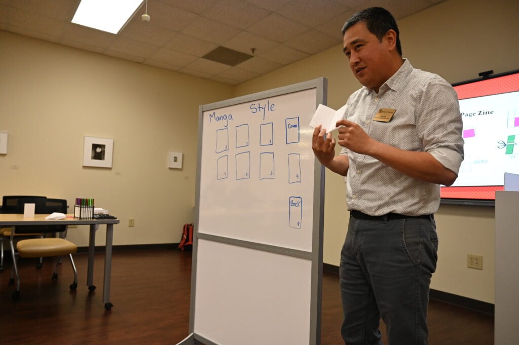 Huy Chu shares a technique to make zines during an International Week event.