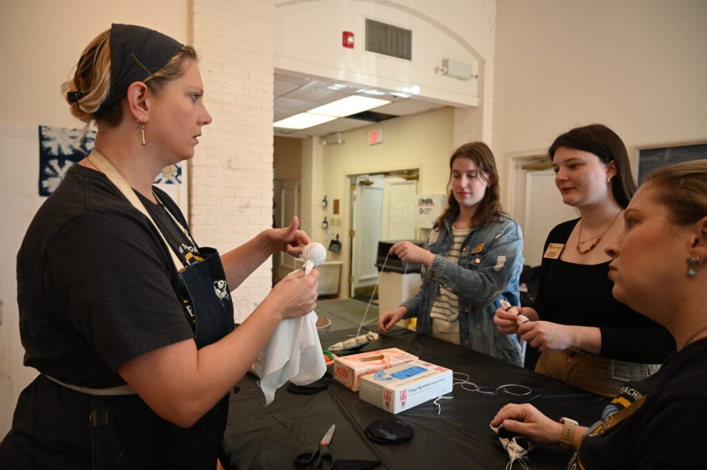 Claudia Wilburn shows the sibori technique for indigo dyeing during International Week.