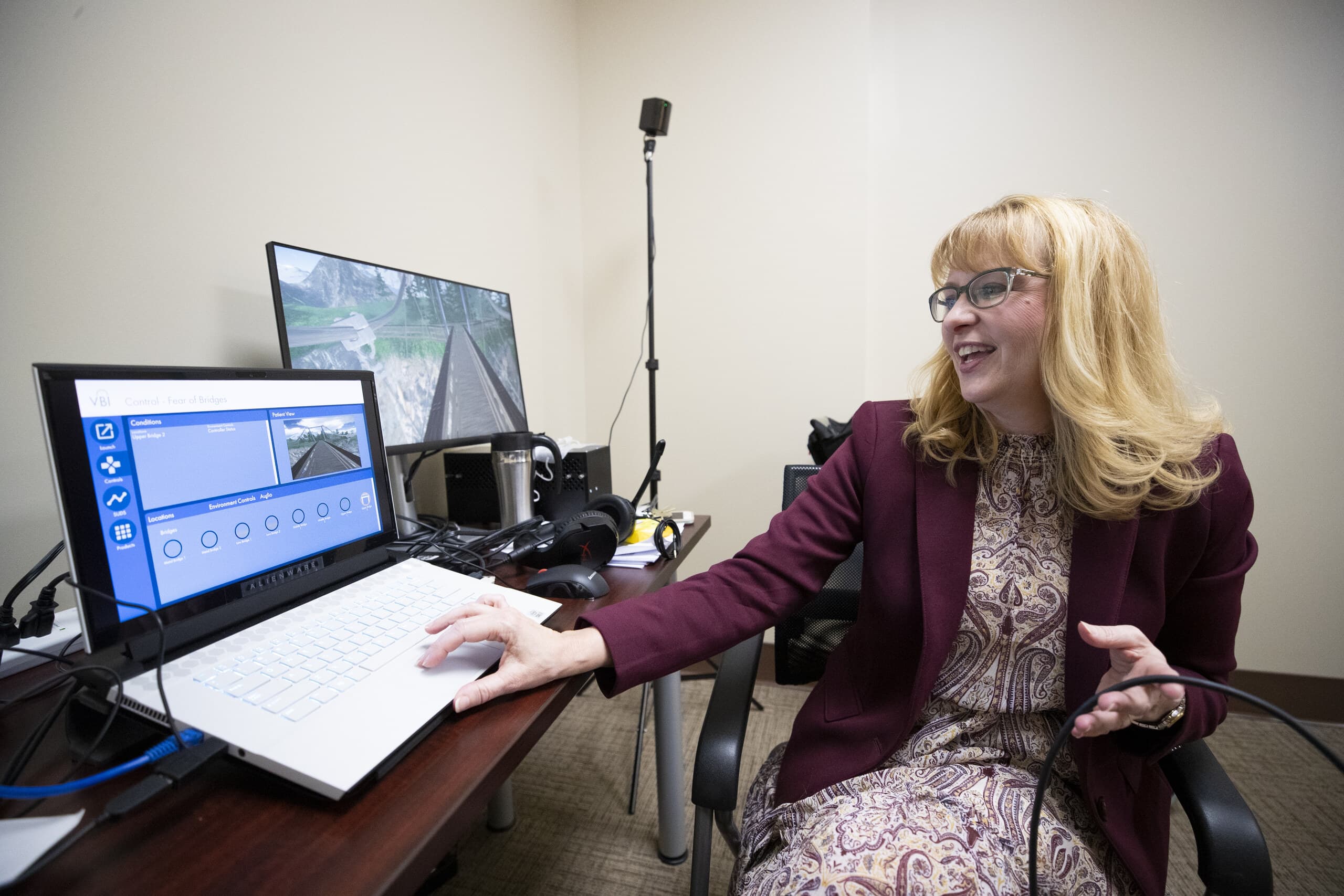 Dr. Julie Battle sits behind a computer set up that is part of the Darby School's virtual reality set up.