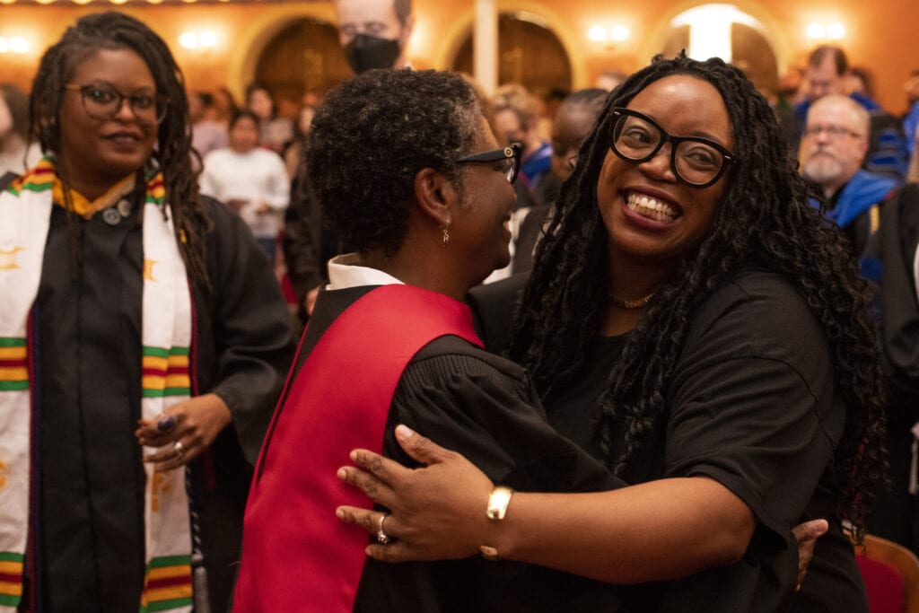 two women hug and smile