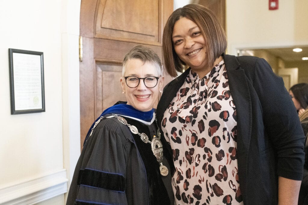 Brenau President Anne Skleder, dressed in academic regalia, poses with Dr. Regina N. Bradley.