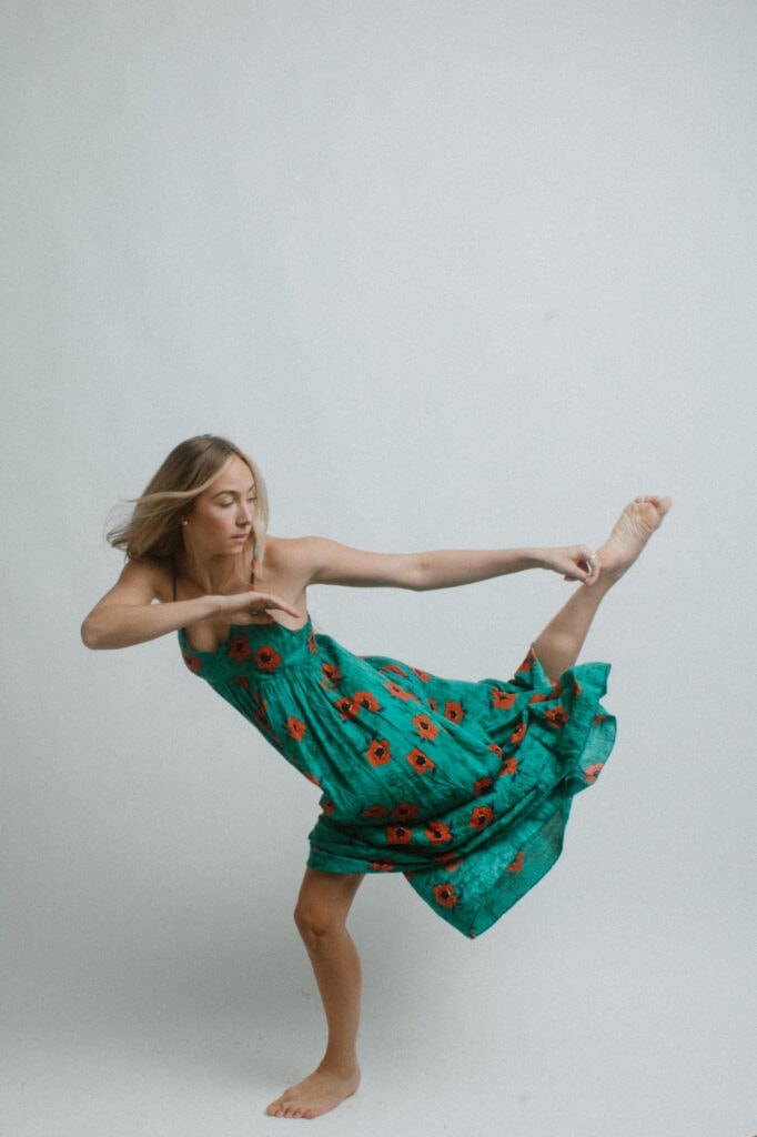 A woman in a green dress dances