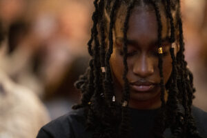 close up of young black woman with braids with eyes closed