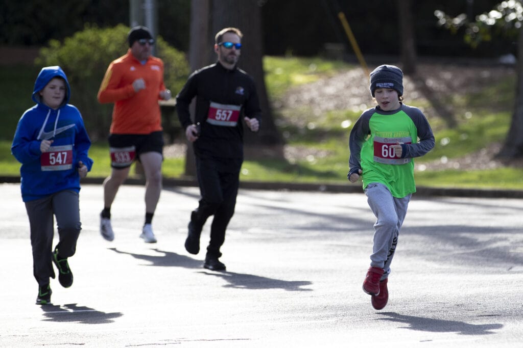 Two boys race each other at the Dempsey Dash