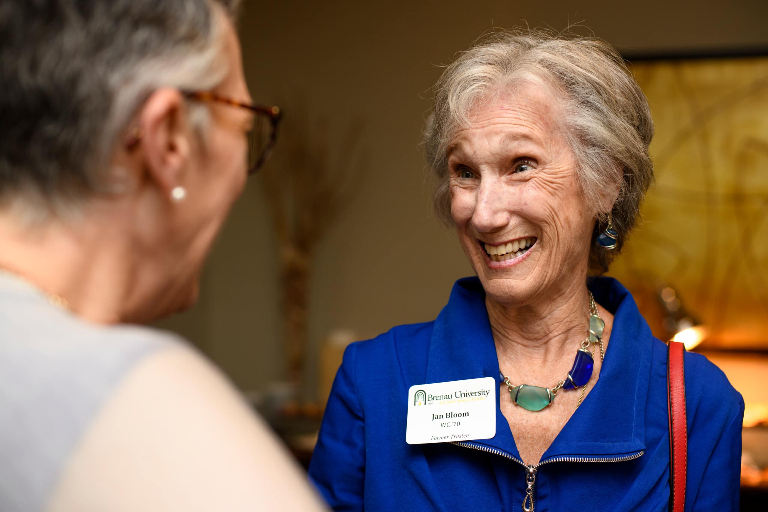 President Anne Skleder and Jan Bloom talk at an alumni event in Buckhead.