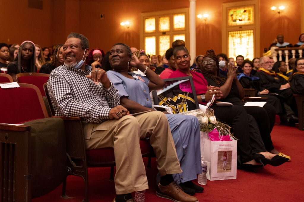 The family of Miracle Jordan smile from the front row of Pearce Auditorium.