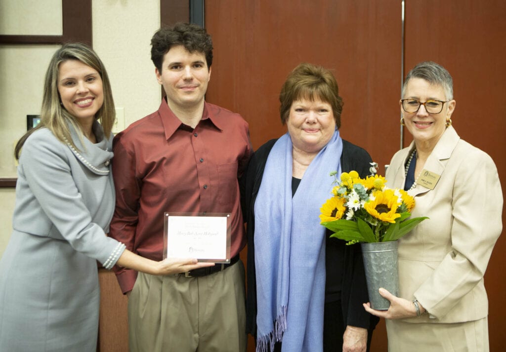 Mary Evan Hobgood Bannister and her son, Stephen Bannister stand with presenters to accept award on behalf of her mother