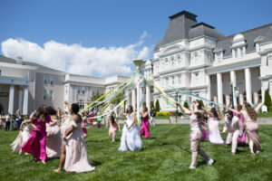 Student walking around the may pole