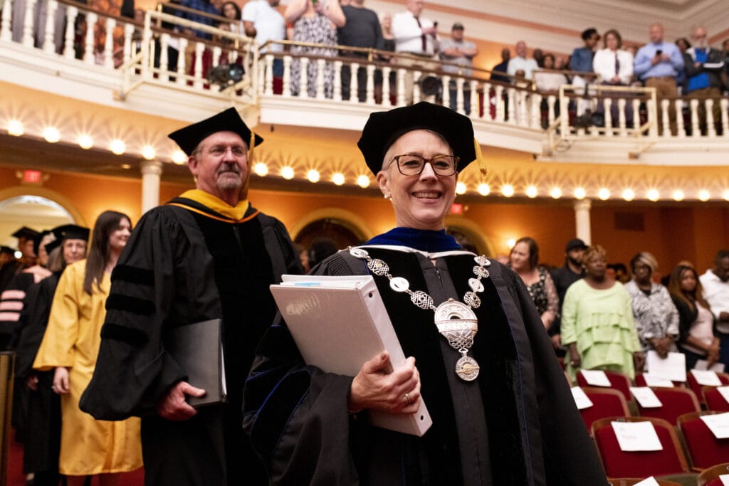 President Anne Skleder processes in to Pearce Auditorium for The Women's College commencement ceremony.