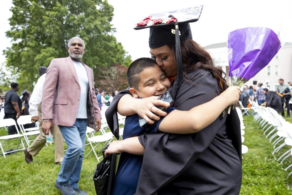 A graduate embraces her son after the commencement ceremony Saturday.