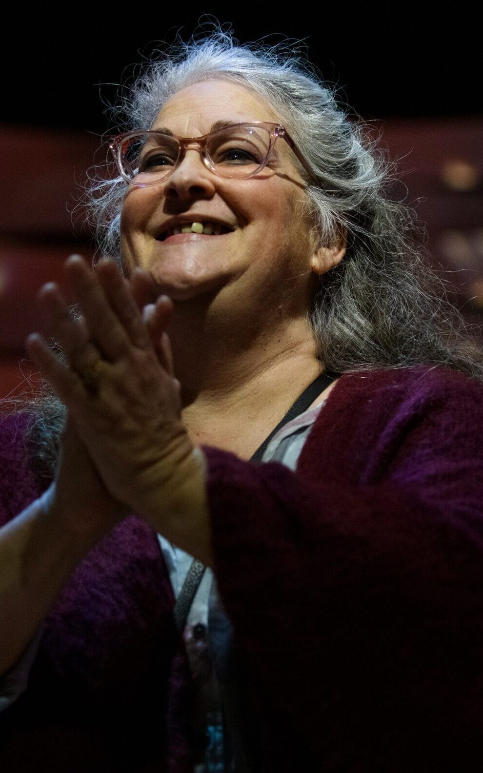 A candid shot of Gay Hammond, clapping after a theatre performance