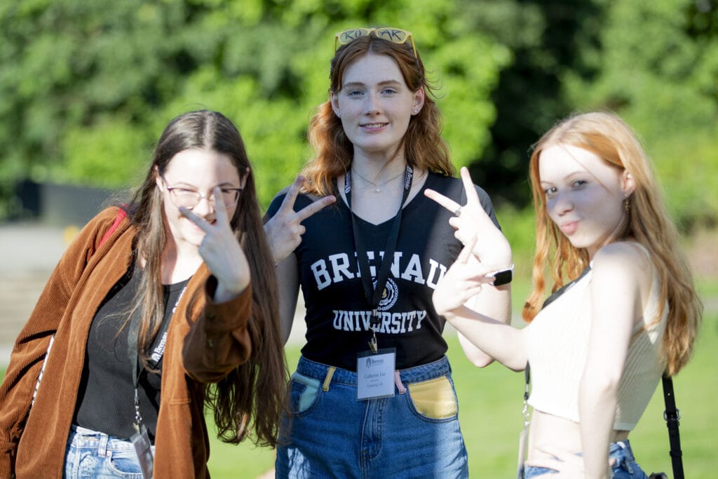 Three female students pose for the camera