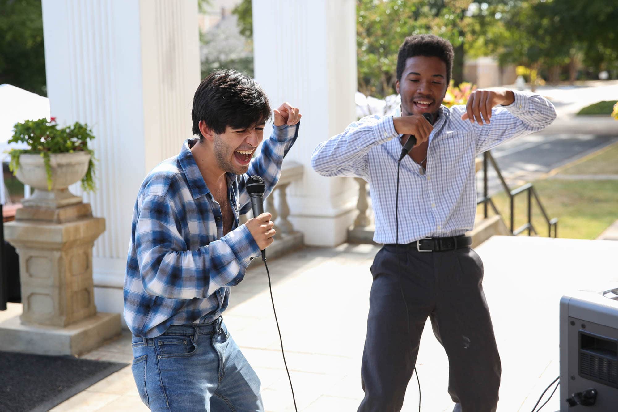 Two students singing karaoke