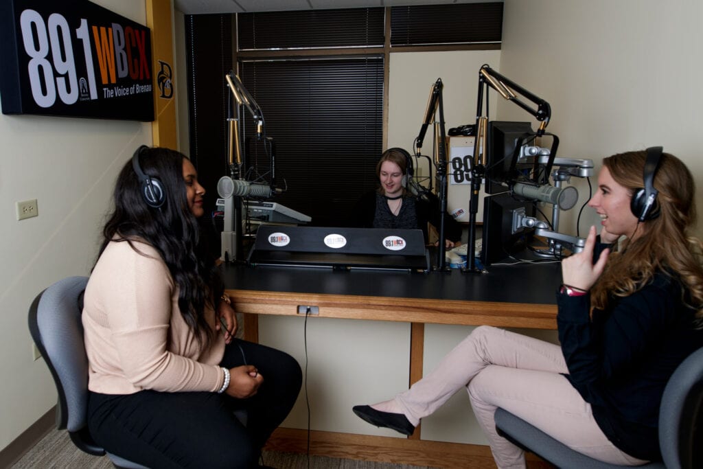 Students record a talk show in the WBCX studio in  2019.