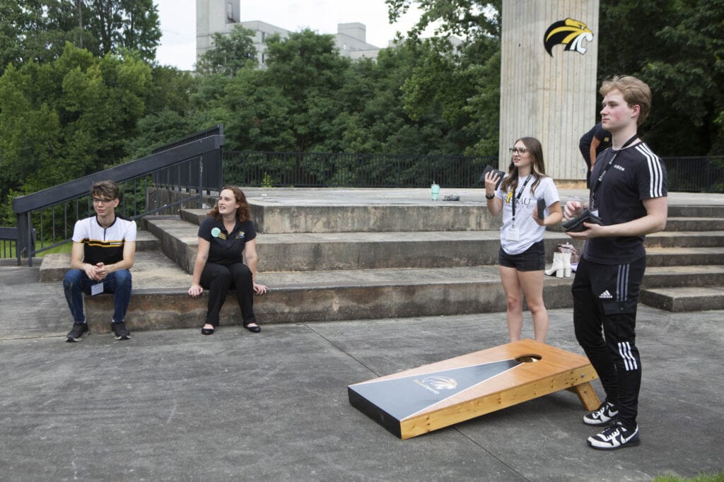 Students playing cornhole