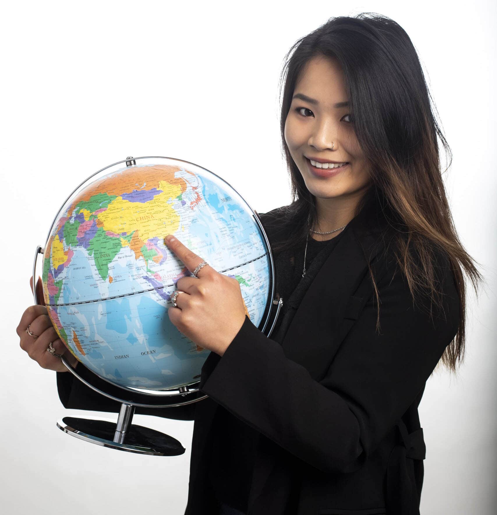 Student pointing at a globe