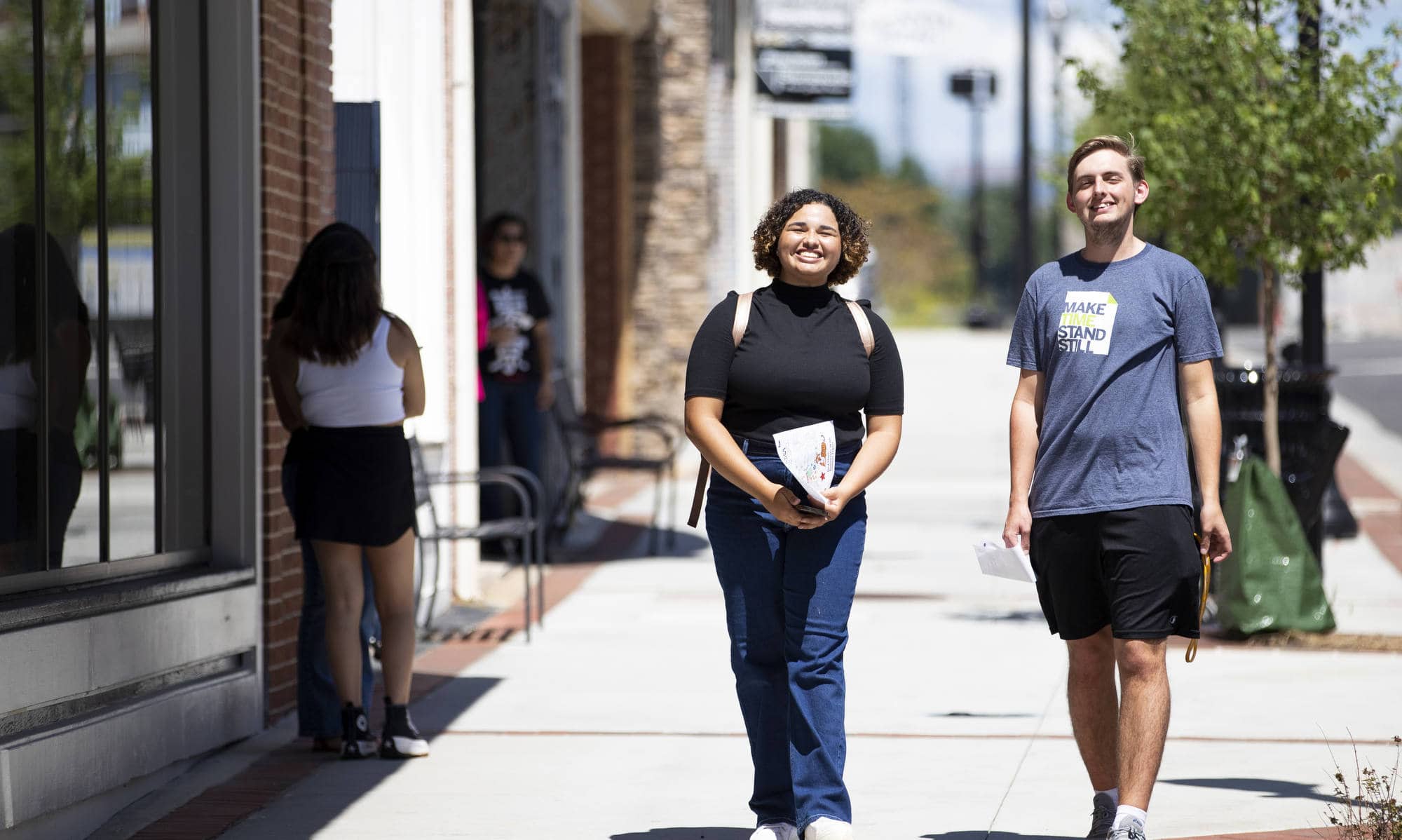Two students walk to the downtown Gainesville square