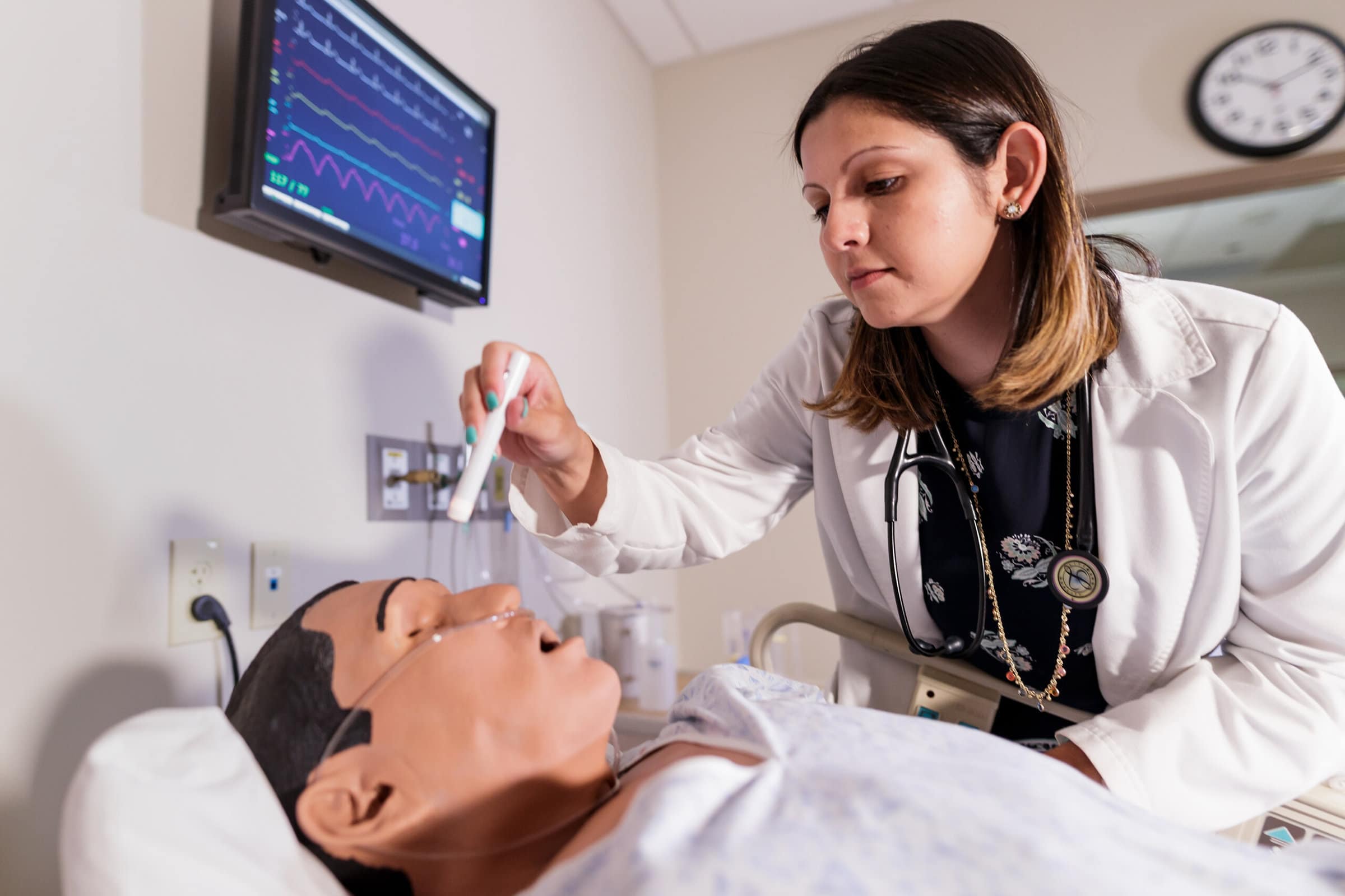Tonya Scott checks the pupils of a patient simulator