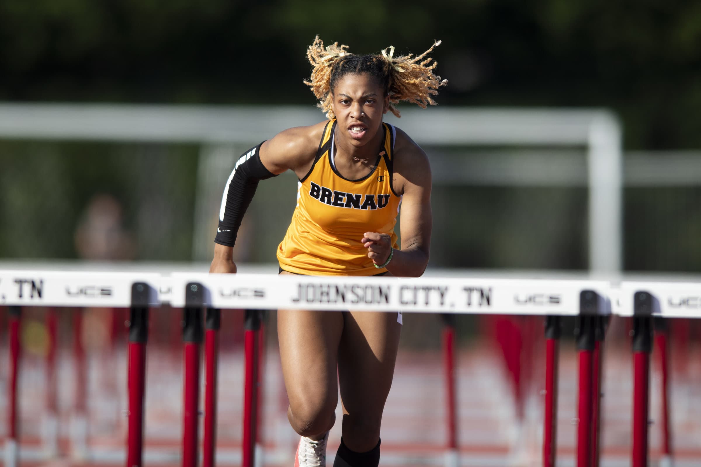 athlete runs hurdles course