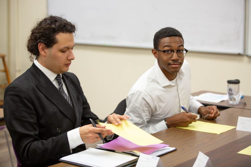Two male students prepare for their mediation session