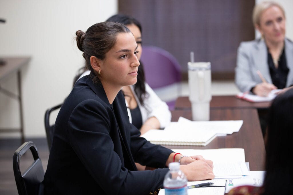 A female student looks on during a mediation session