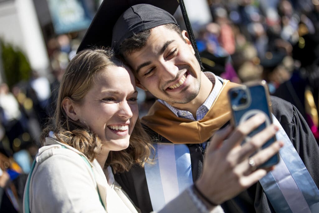 A selfie taken by a graduate and his companion