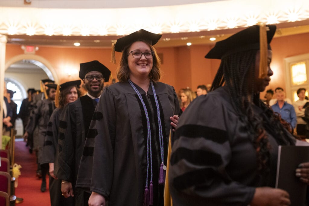 Graduates process into Pearce Auditorium