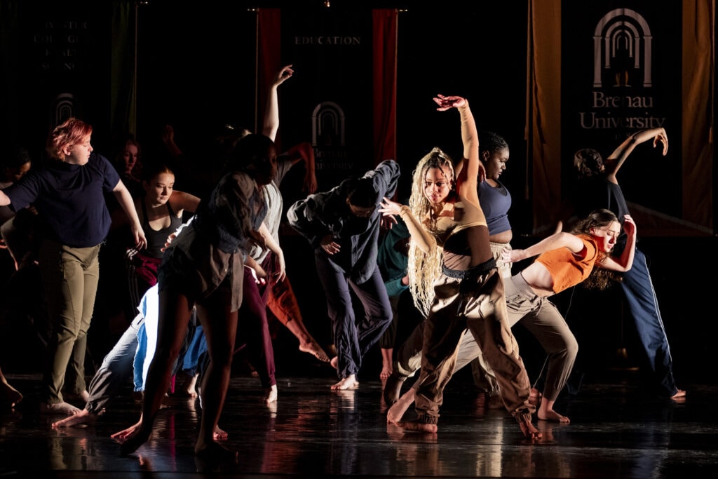 Dancers moved about the dark stage during their performance