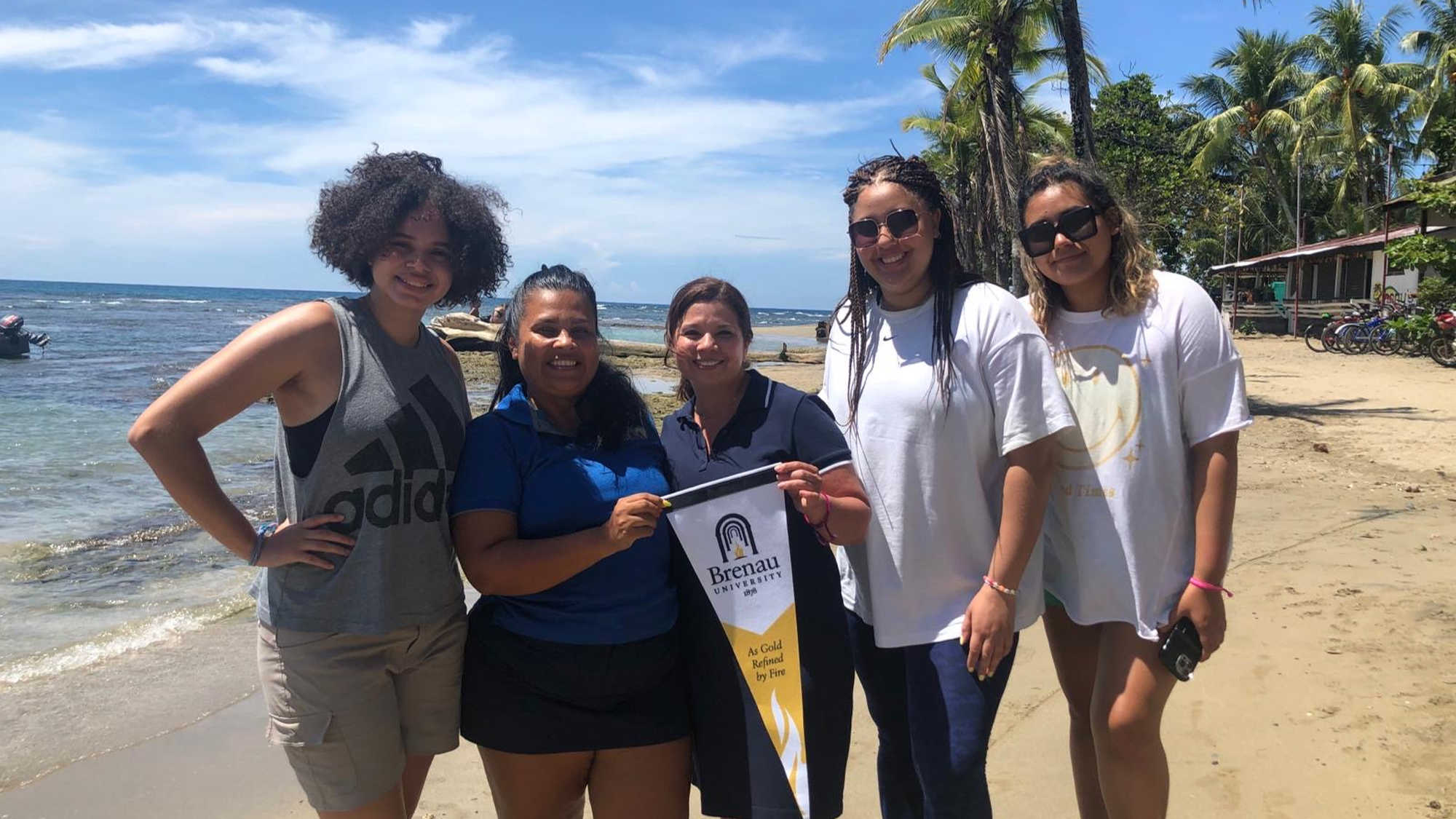 Students and faculty pose for a photo on the beach in Costa Rica