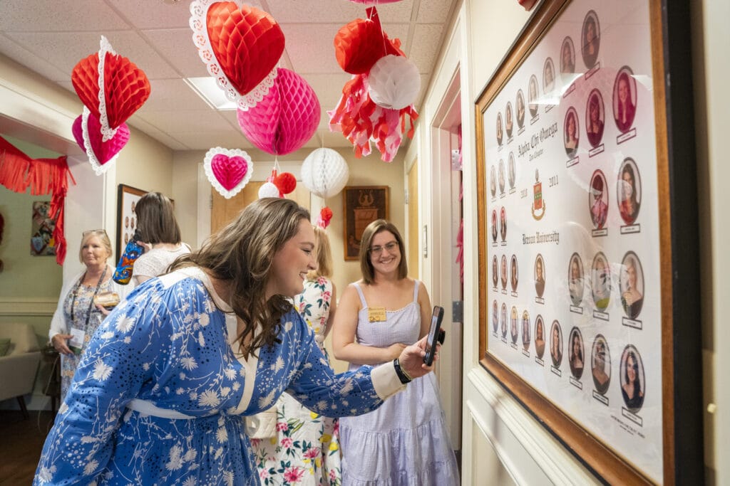 An Alpha Chi Omega sister takes a photo of her composite