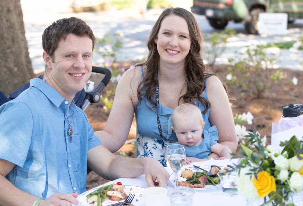 Alumna Dayle Boggs and her husband and daughter enjoy the champagne brunch