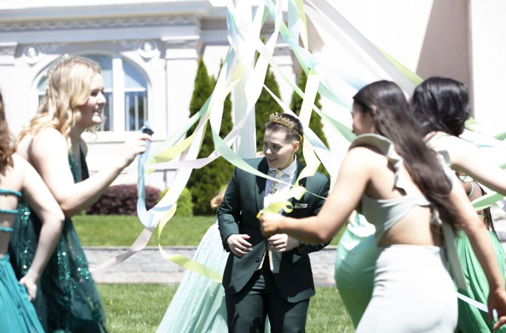 May Queen Payton Hicks stands under the May Pole as it is wrapped